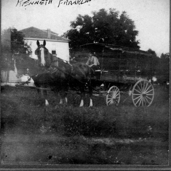 Wildwood Historical Society - Kenneth Franklin - Driving large wagon and team of horses Franklin house in Grover background - 1922